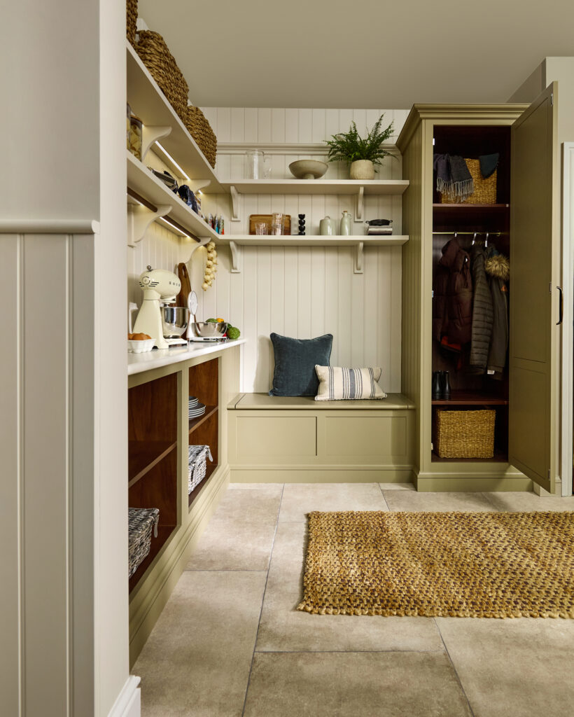 Bespoke walk-in pantry and luxury boot room featuring tall cupboard storage, bench seating, and open shelving for pantry supplies.
