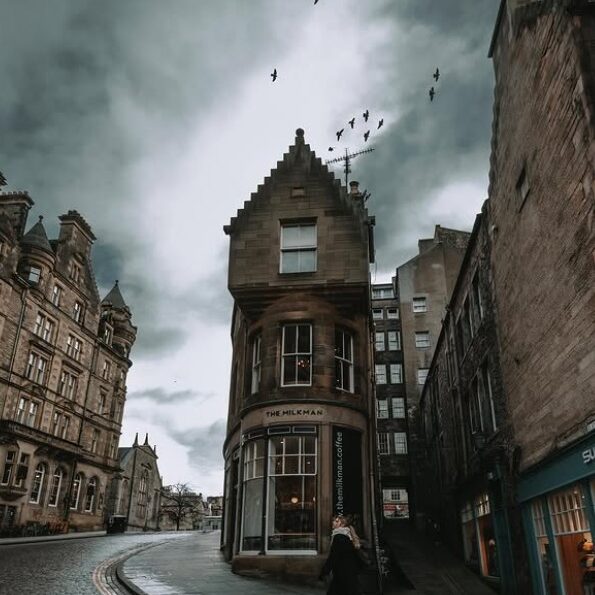 edinburgh coffee shop with moody skies and cobbled streets