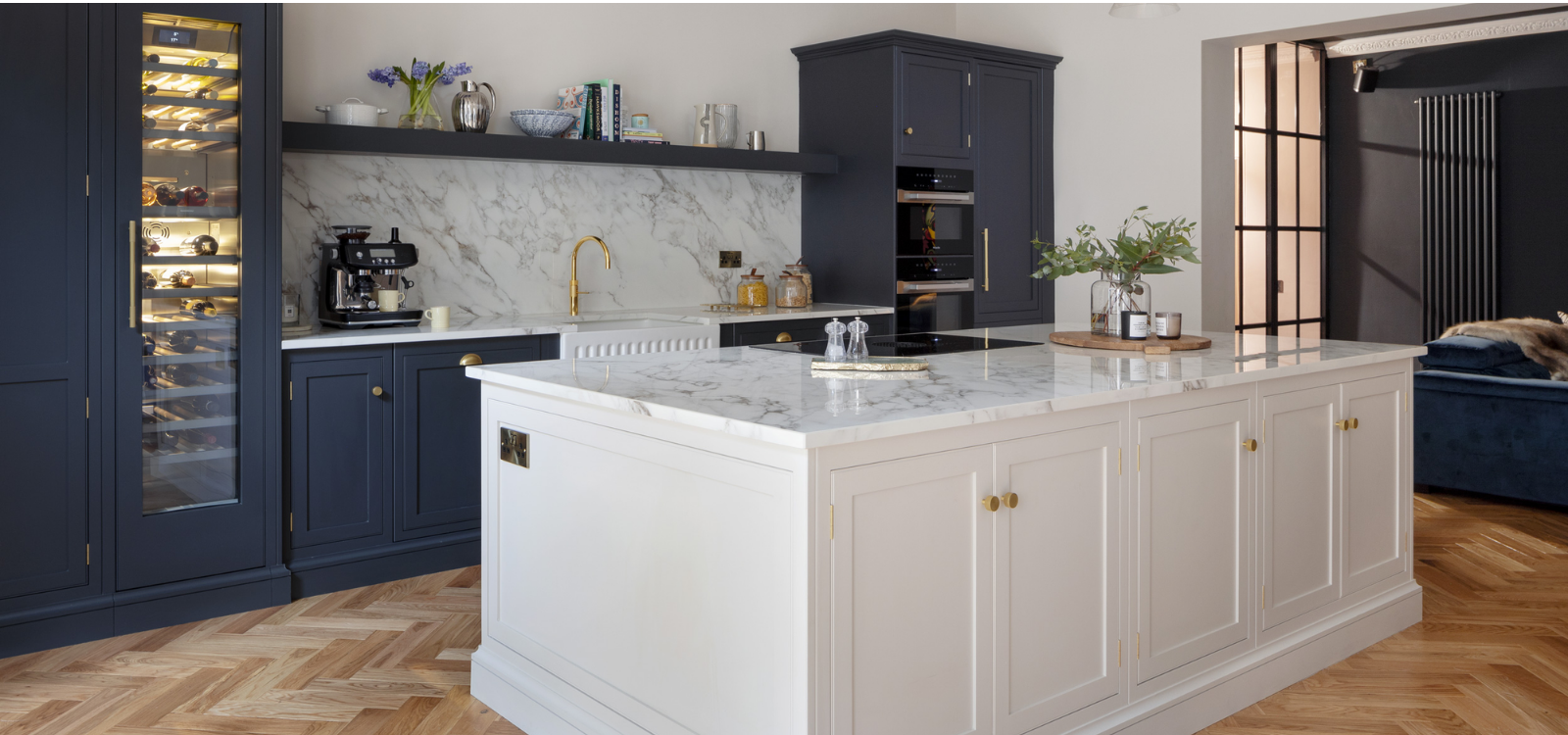 Navy and white bespoke kitchen with integrated ovens and wine fridge