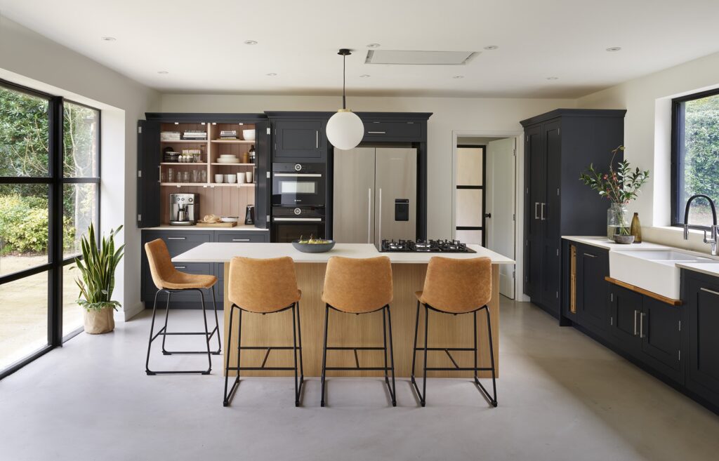 Charcoal grey bespoke kitchen with oak island and hidden coffee station