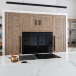 Shaker kitchen island with flush hob and marble worktop and open shelving