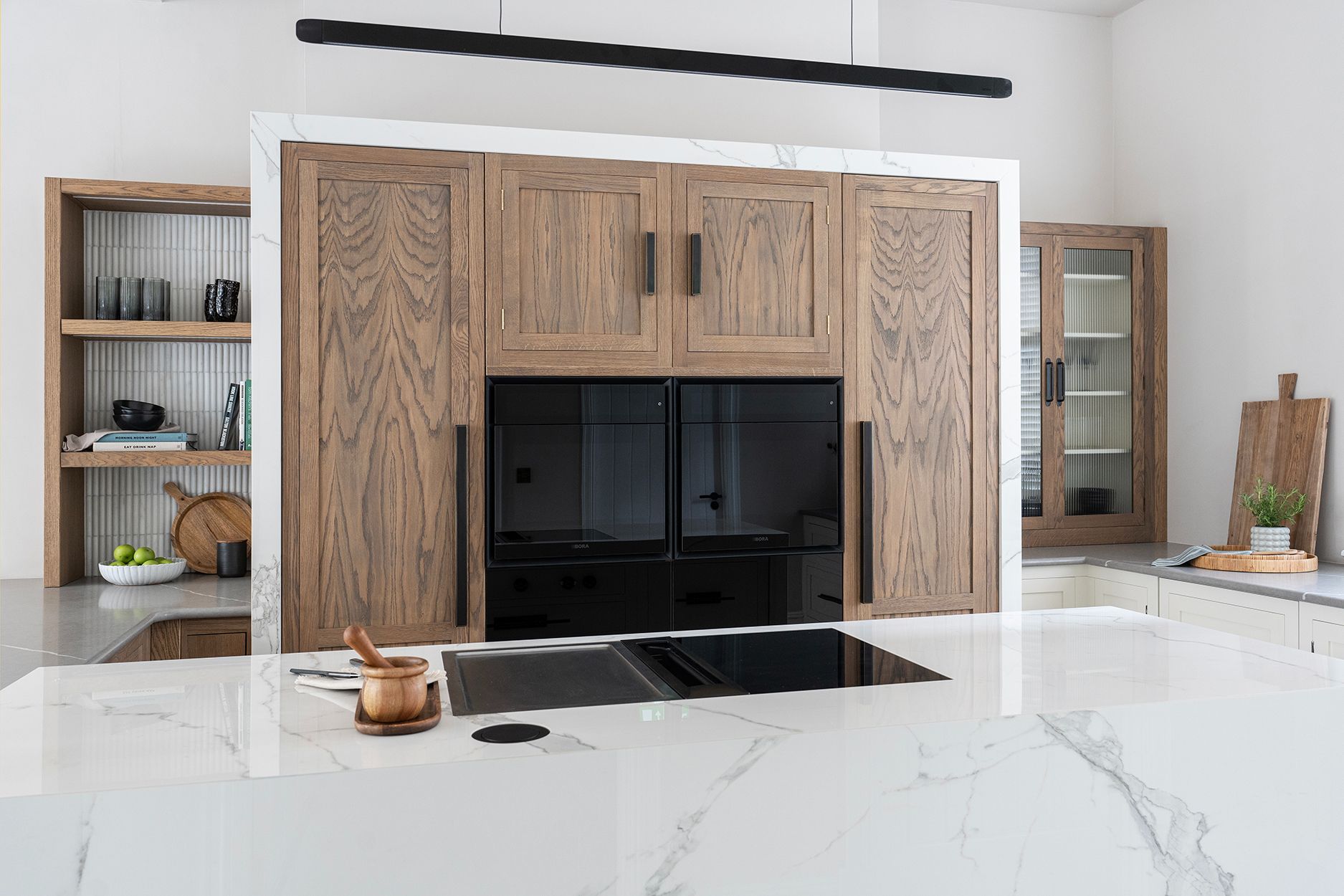 Shaker kitchen island with flush hob and marble worktop and open shelving