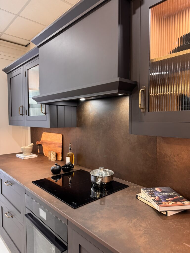 Hidden extractor hood and induction hob in dark kitchen design