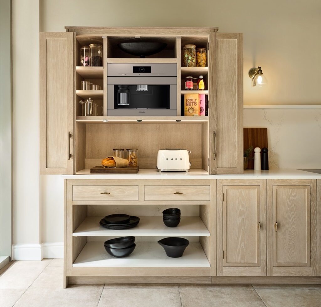 Hidden breakfast larder with integrated coffee machine in washed oak kitchen