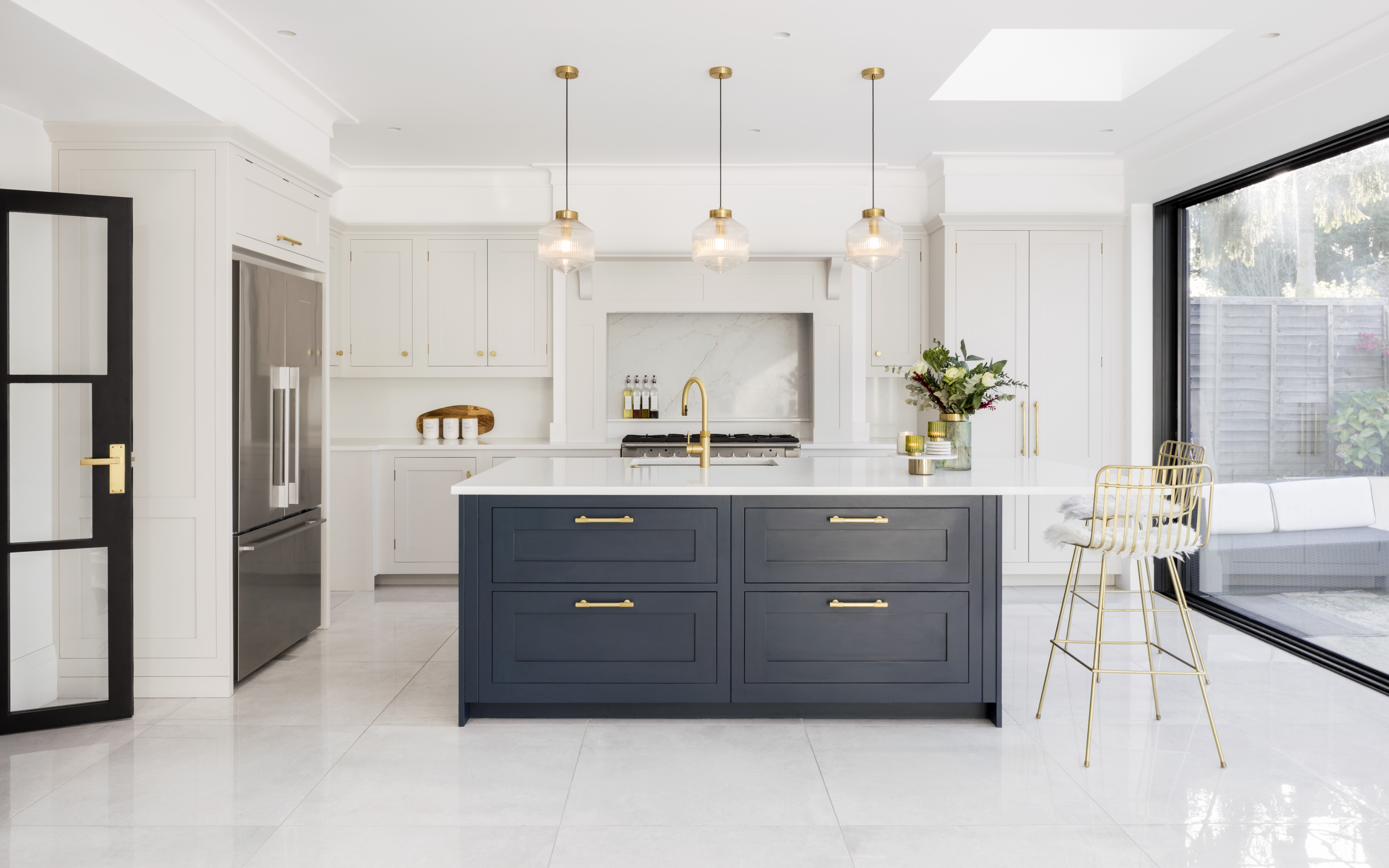 White open plan kitchen with navy blue island