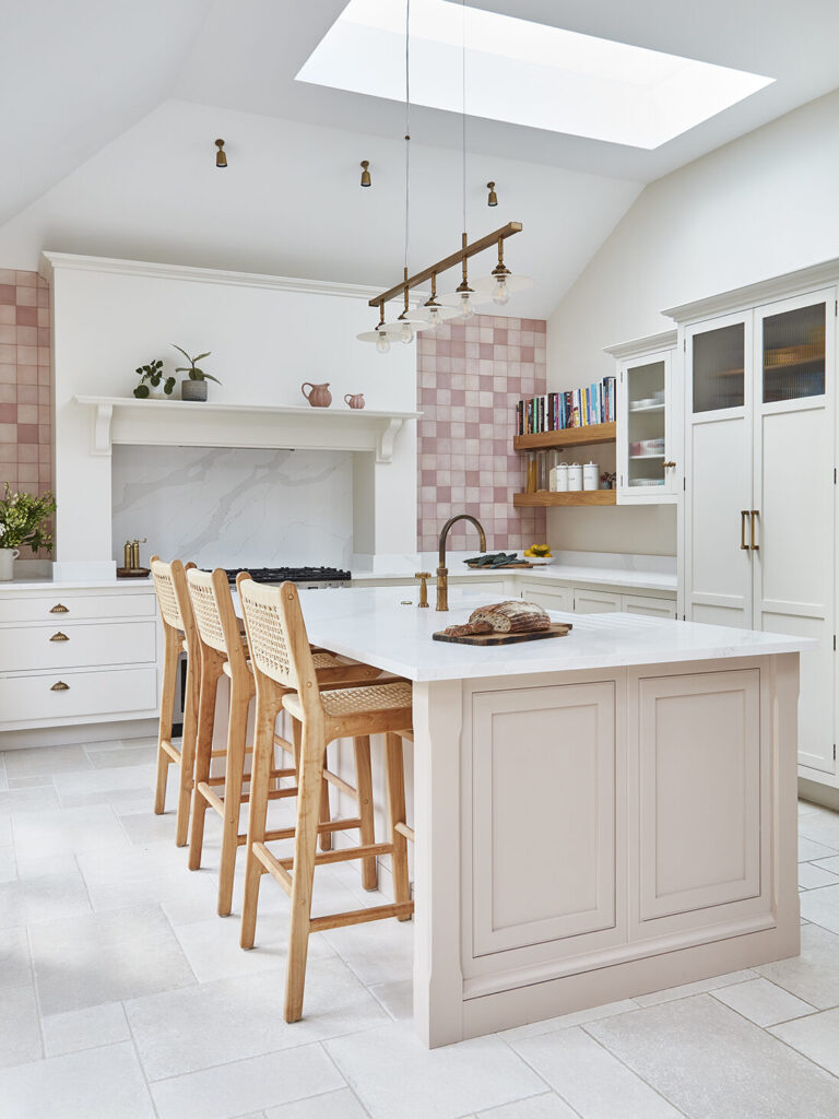 Warm neutral kitchen design with pink accents and natural wood
