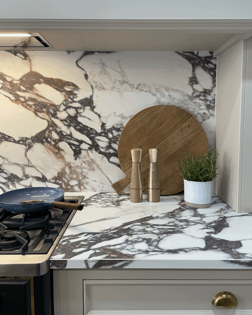 Bespoke kitchen with marbled stone Calcatta Viola backsplash and worktop