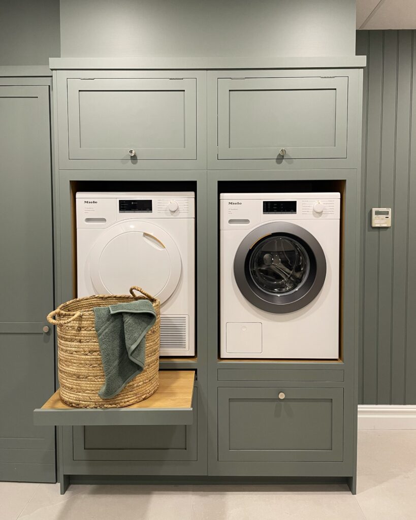 Green bespoke utility space with hidden shelving