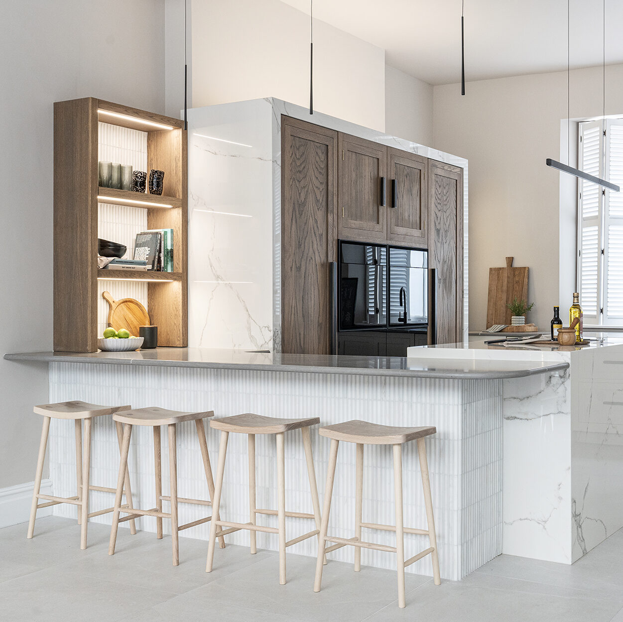 Bespoke white kitchen with textured tiling and lighting