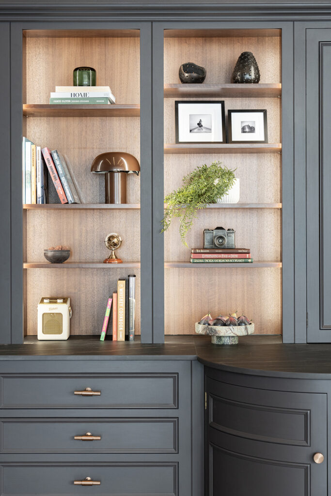 Dark kitchen design with open shelving and ambient light