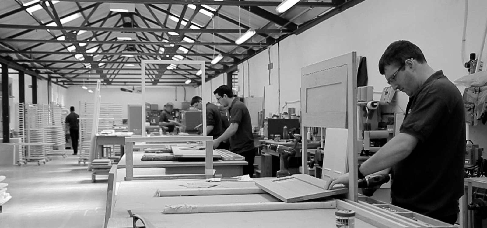 Kitchen workshop with craftsmen handcrafting bespoke kitchens