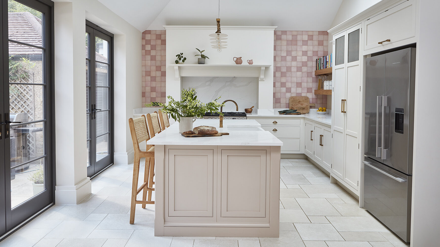 Pink luxury kitchen with island and seating, featuring feminine design with contrasting details