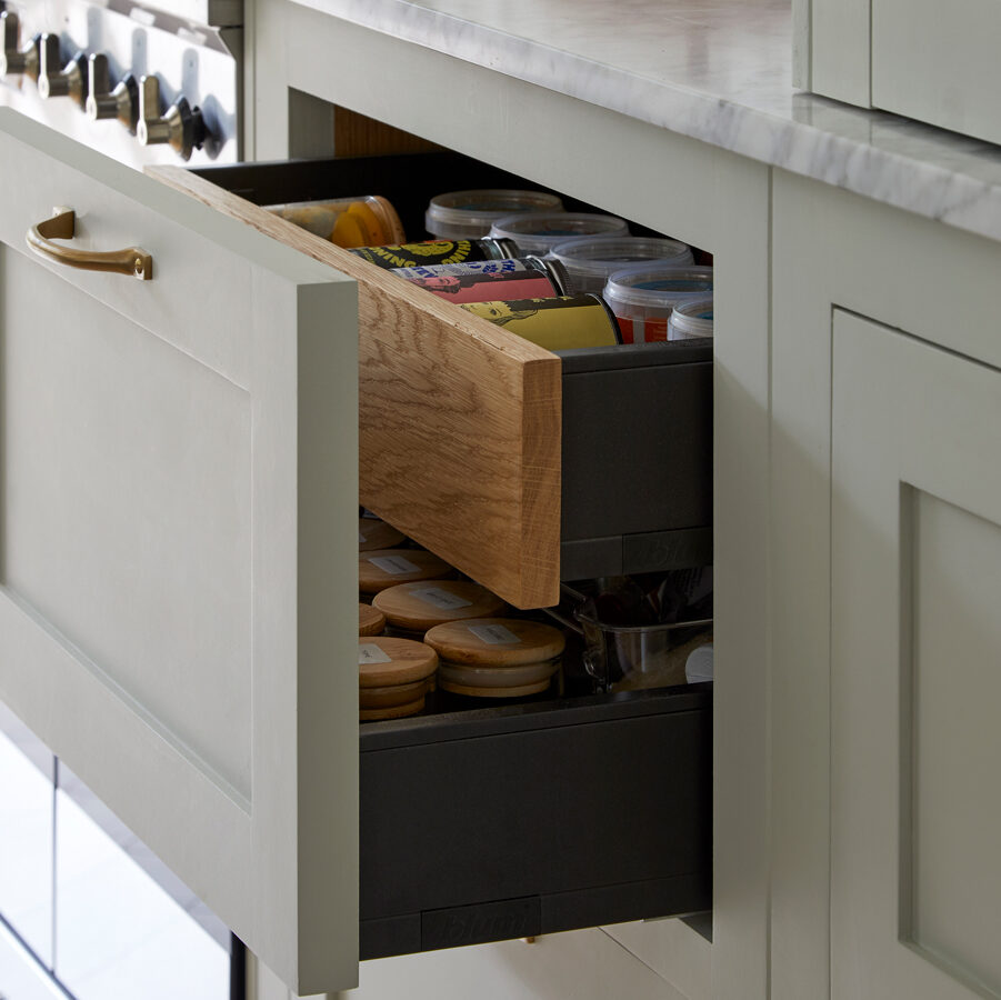 Sage green kitchen with bespoke kitchen storage