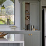 Tall larder cabinets providing hidden breakfast and pantry storage