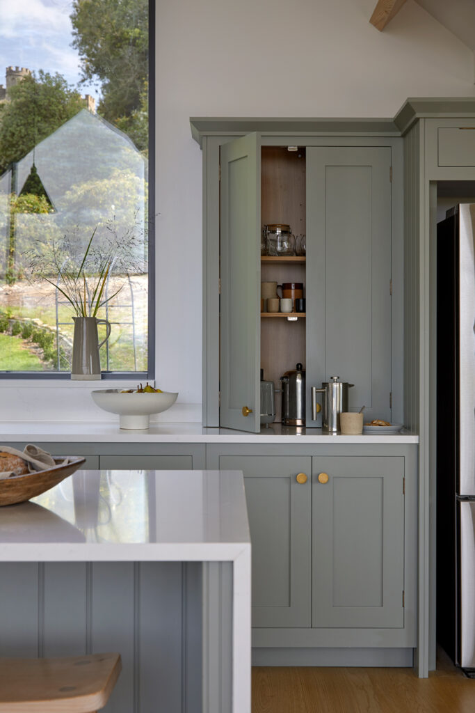 Tall larder cabinets providing hidden breakfast and pantry storage