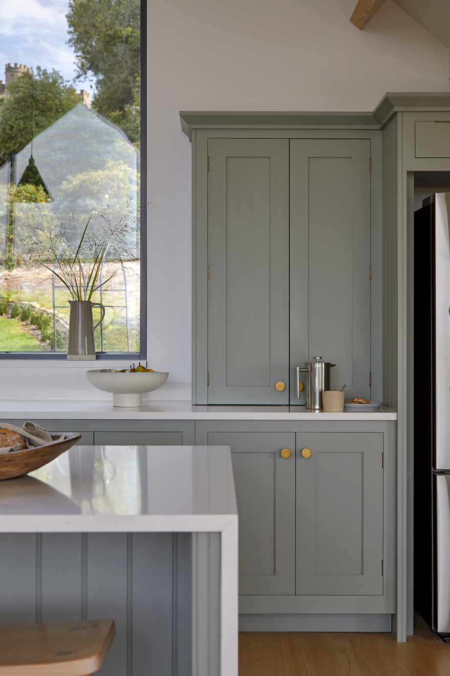 Tall larder cabinets providing hidden breakfast and pantry storage