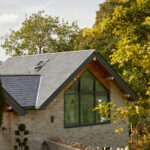 Exterior view of the gable end window illuminating the open plan kitchen.