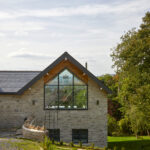 Large trapezium gable window in countryside farmhouse style home