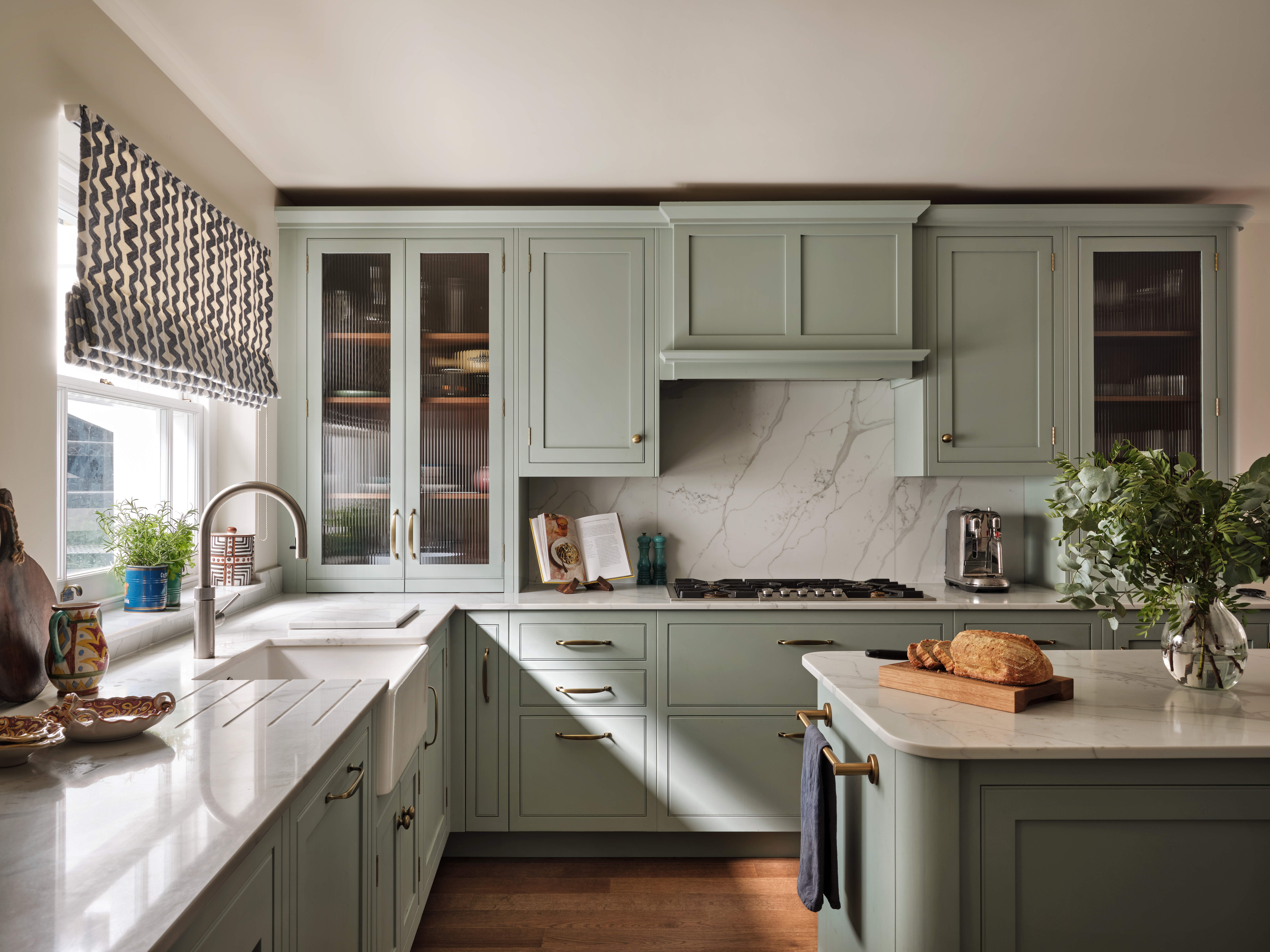 Traditional Arbor luxury kitchen in sage green with brass handles and integrated gas hob