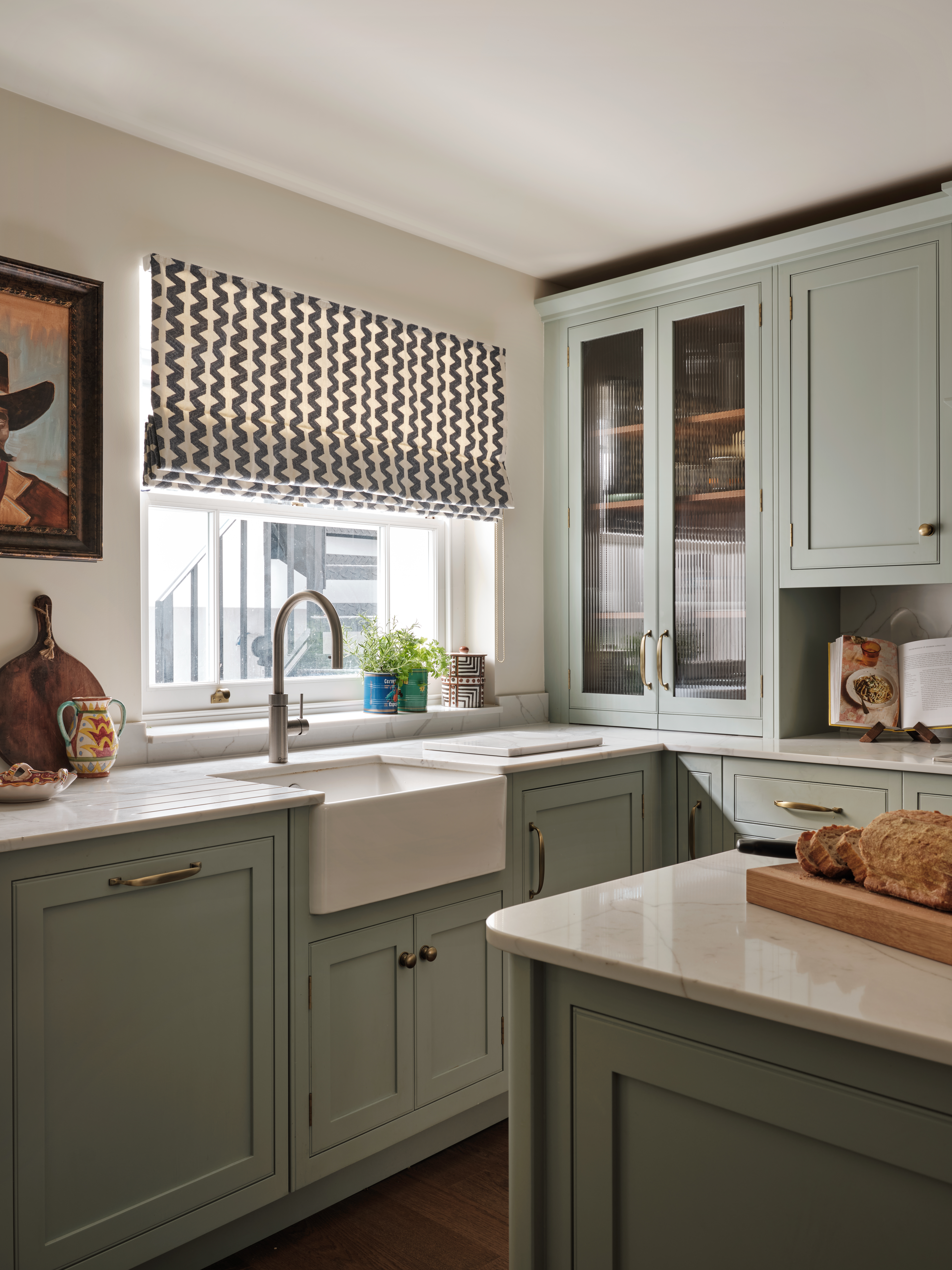 Farmhouse kitchen featuring sage cabinetry, Belfast sink and sash window