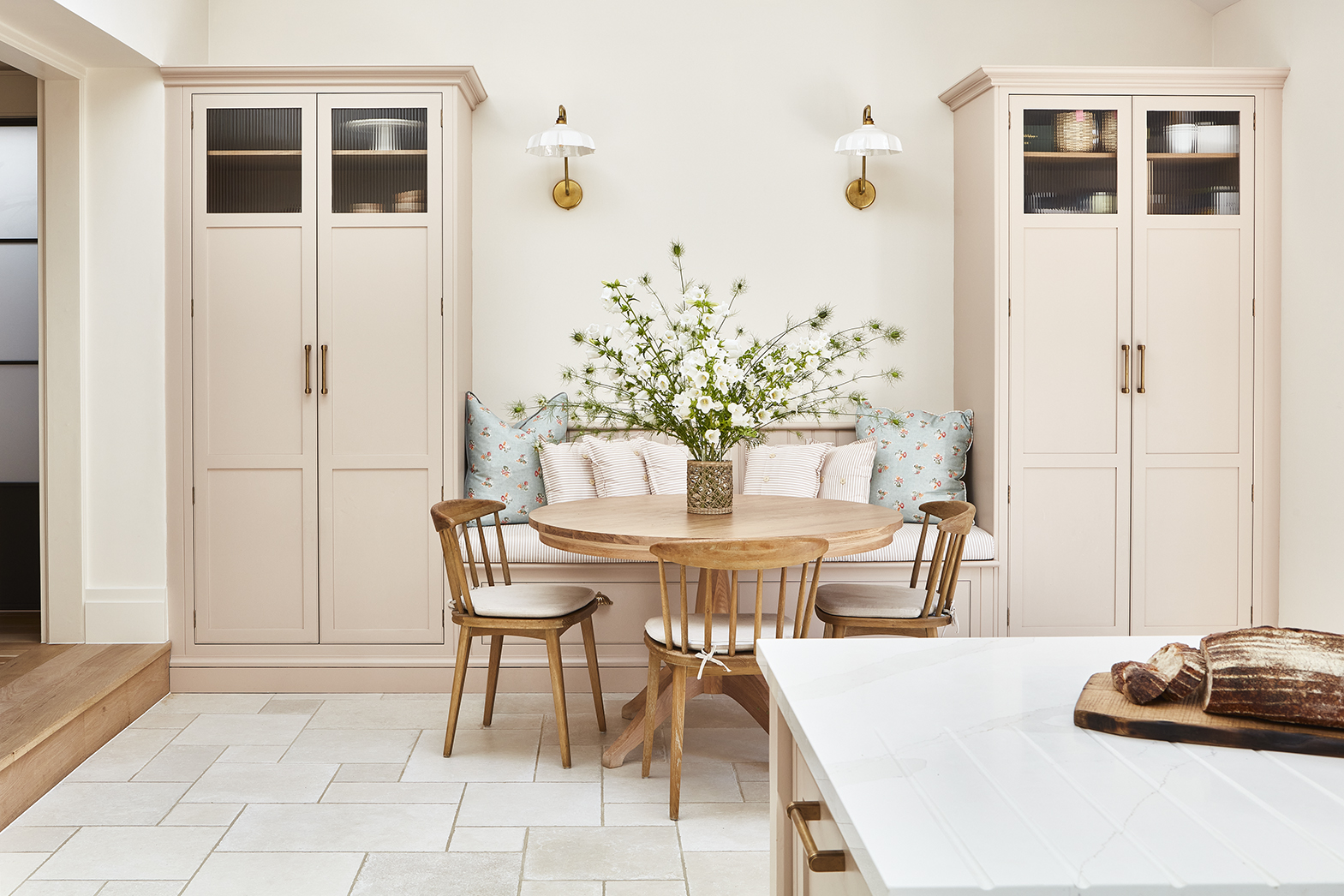 Soft pink open plan kitchen diner with symmetrical design