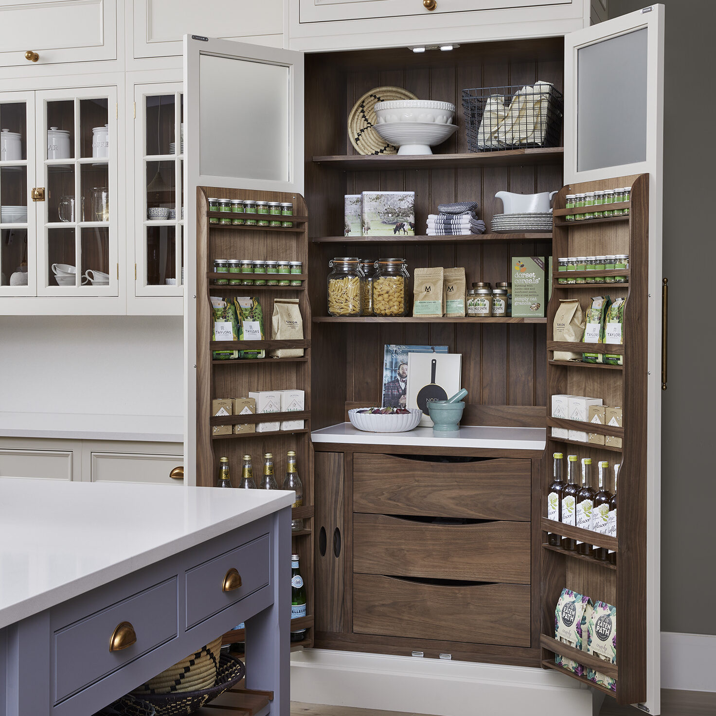 Pantry cupboard with bespoke storage solutions and dark walnut internals