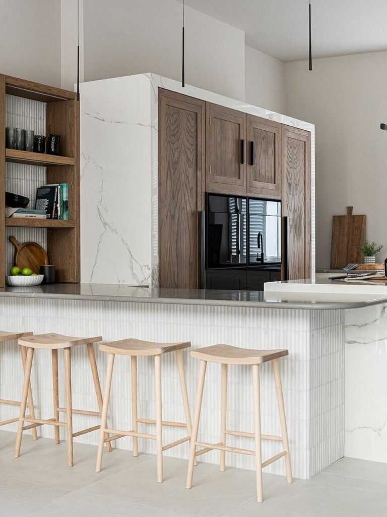 Wooden and white kitchen with L shape layout, social seating and bespoke kitchen design