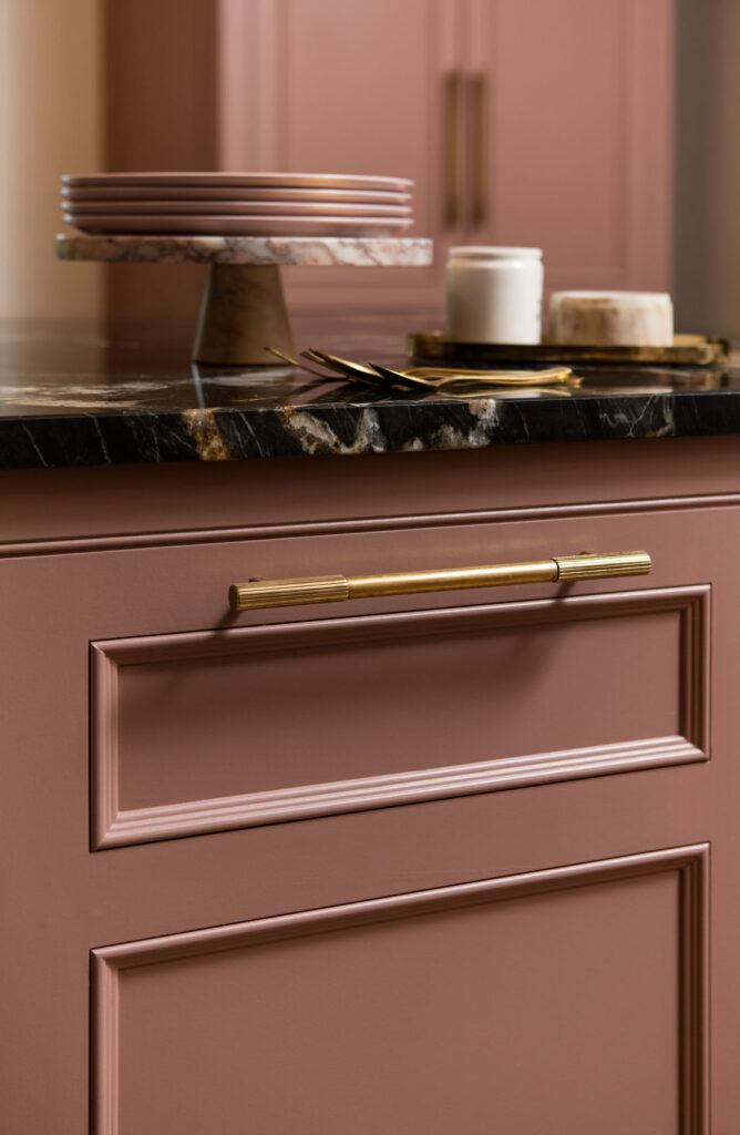 Dusky pink kitchen design with luxury brass hardware