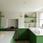 Bespoke kitchen with green kitchen cabinetry and bright white walls