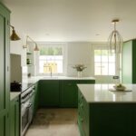 Bespoke Shaker kitchen with minimal decor and green colour palette, featuring a kitchen island with storage