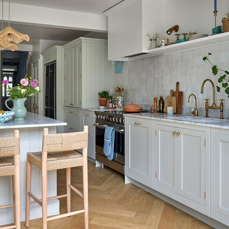 Modern sage green kitchen with island and classic oven