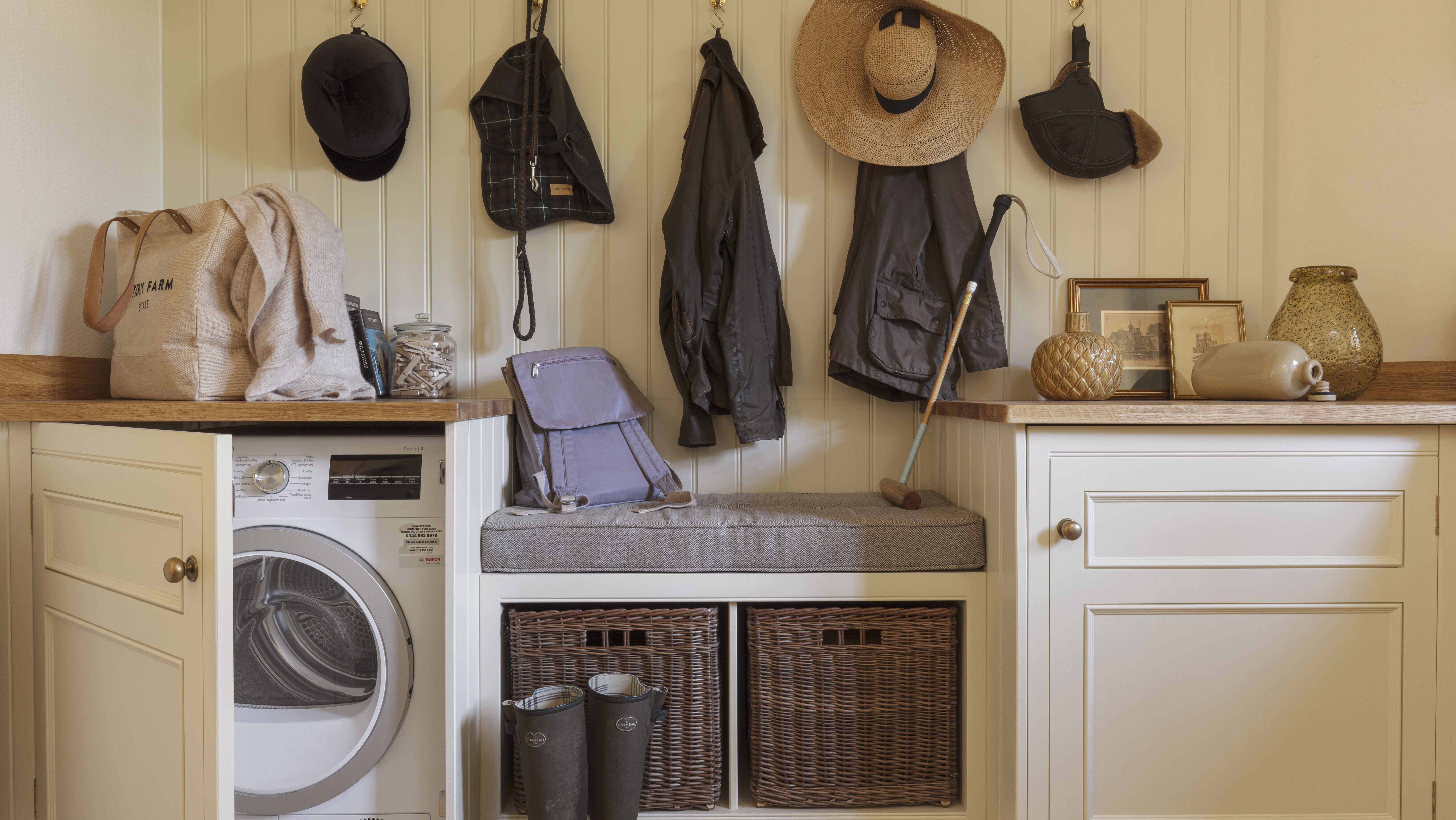 Country utility boot room with hidden washing machine and bench seating