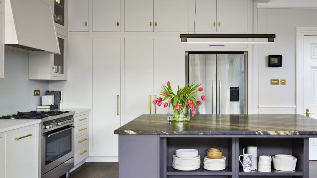 White and navy blue modern kitchen with tall hidden storage and island storage