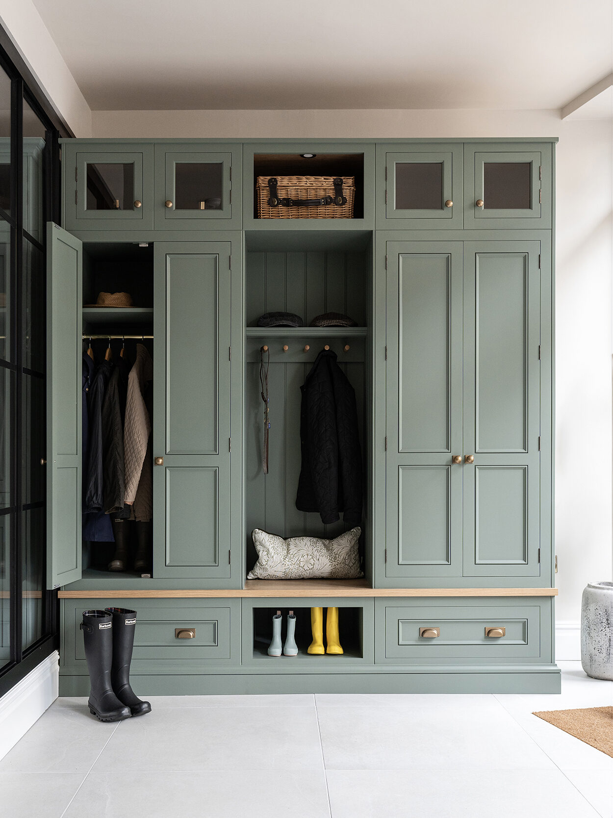 Boot room with tall vertical cupboard storage, shoe storage and bench seating