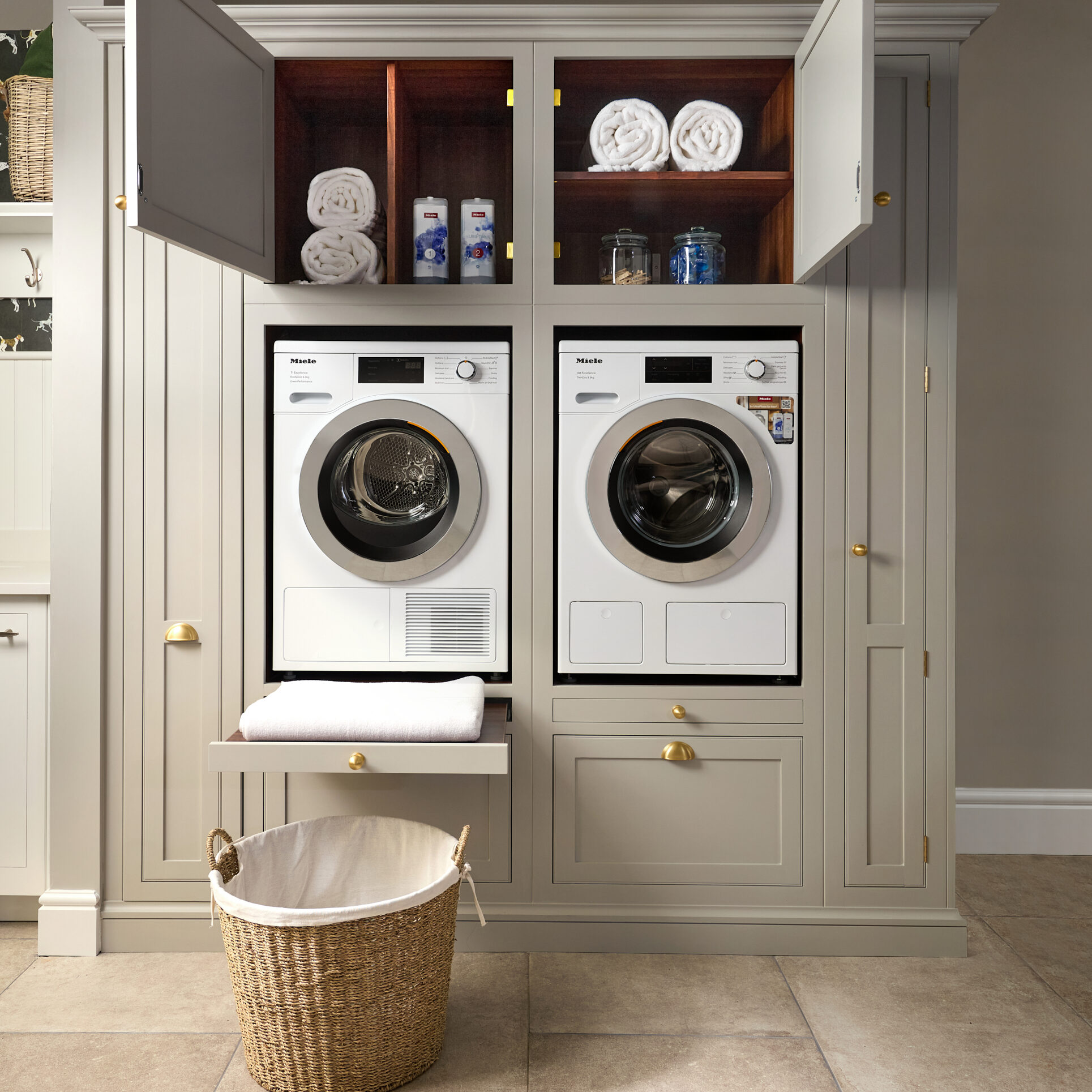 Neutral shaker utility room with side by side washer dryer, tall cabinet space and pull out shelves for laundry baskets