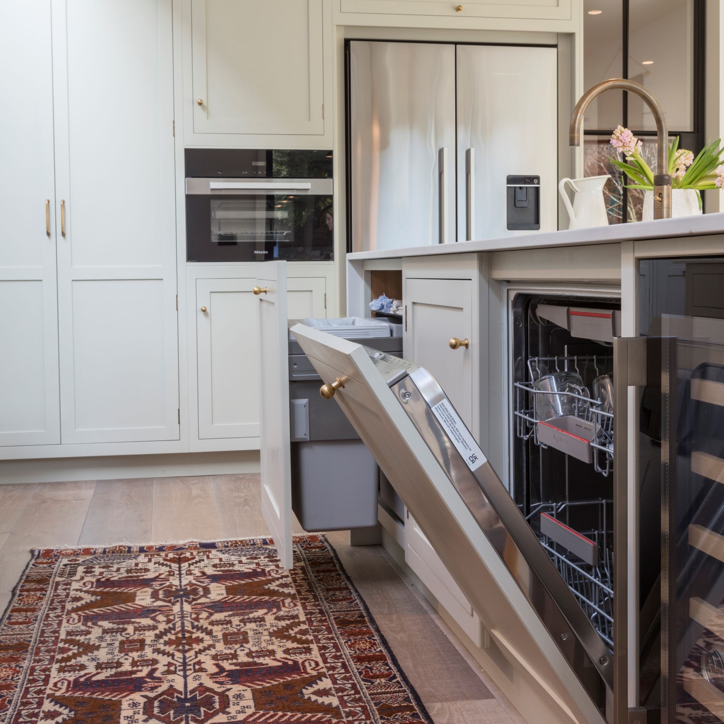 Integrated dishwasher in luxury kitchen with classic kitchen cabinetry and bespoke storage