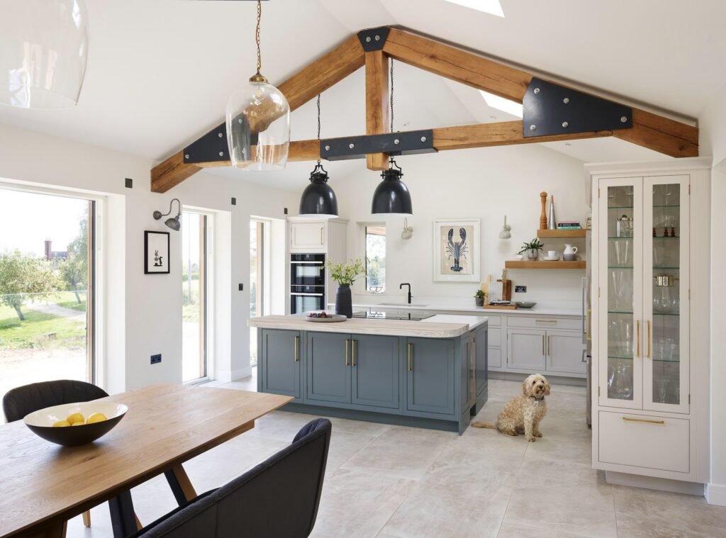 Blue kitchen island with large format floor tiles in neutral shade