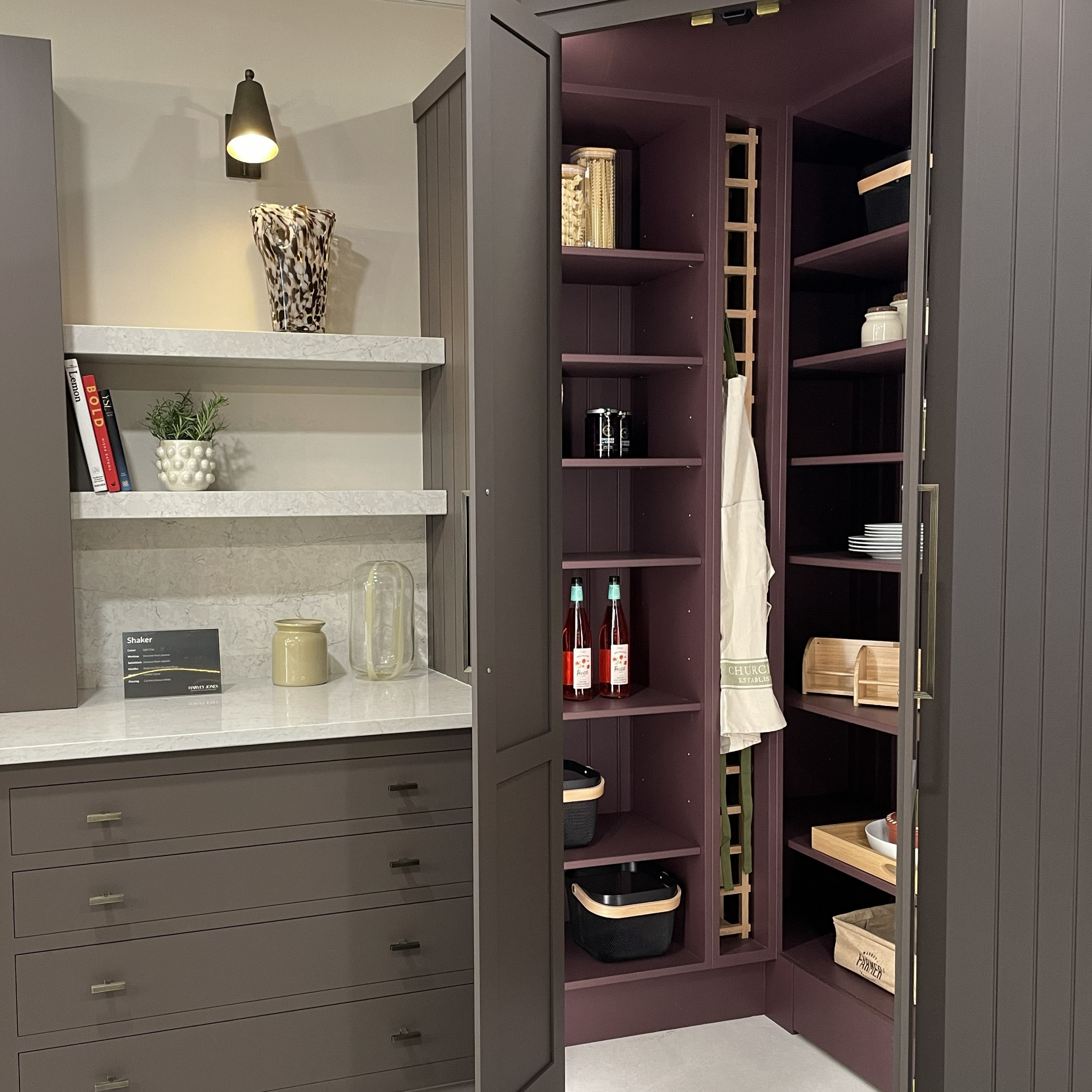 Dark plum corner pantry with deep shelves, hanging space and appliance storage