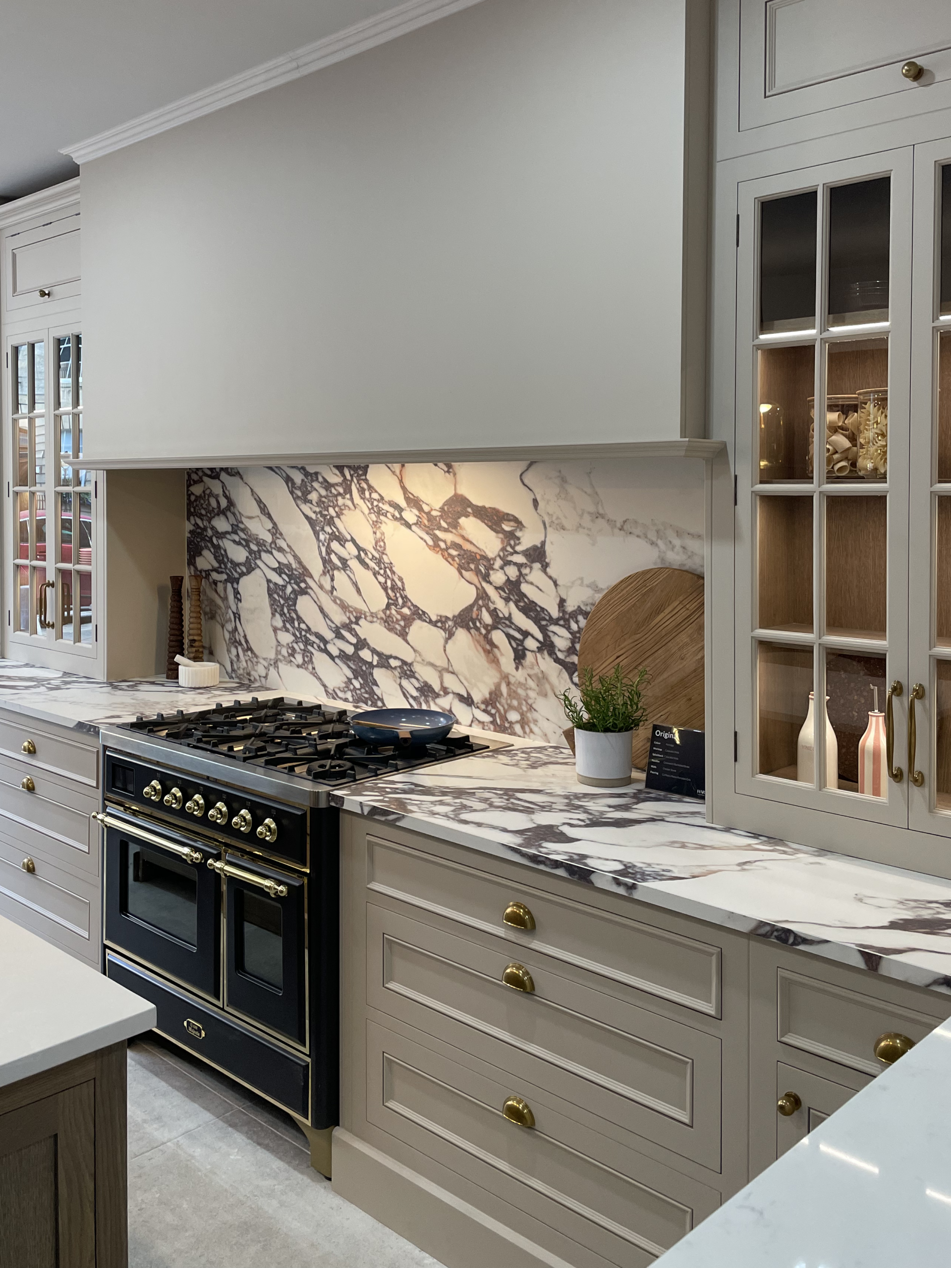 Calactta viola marble countertop and splashback with neutral kitchen cabinetry for layered tactile materials