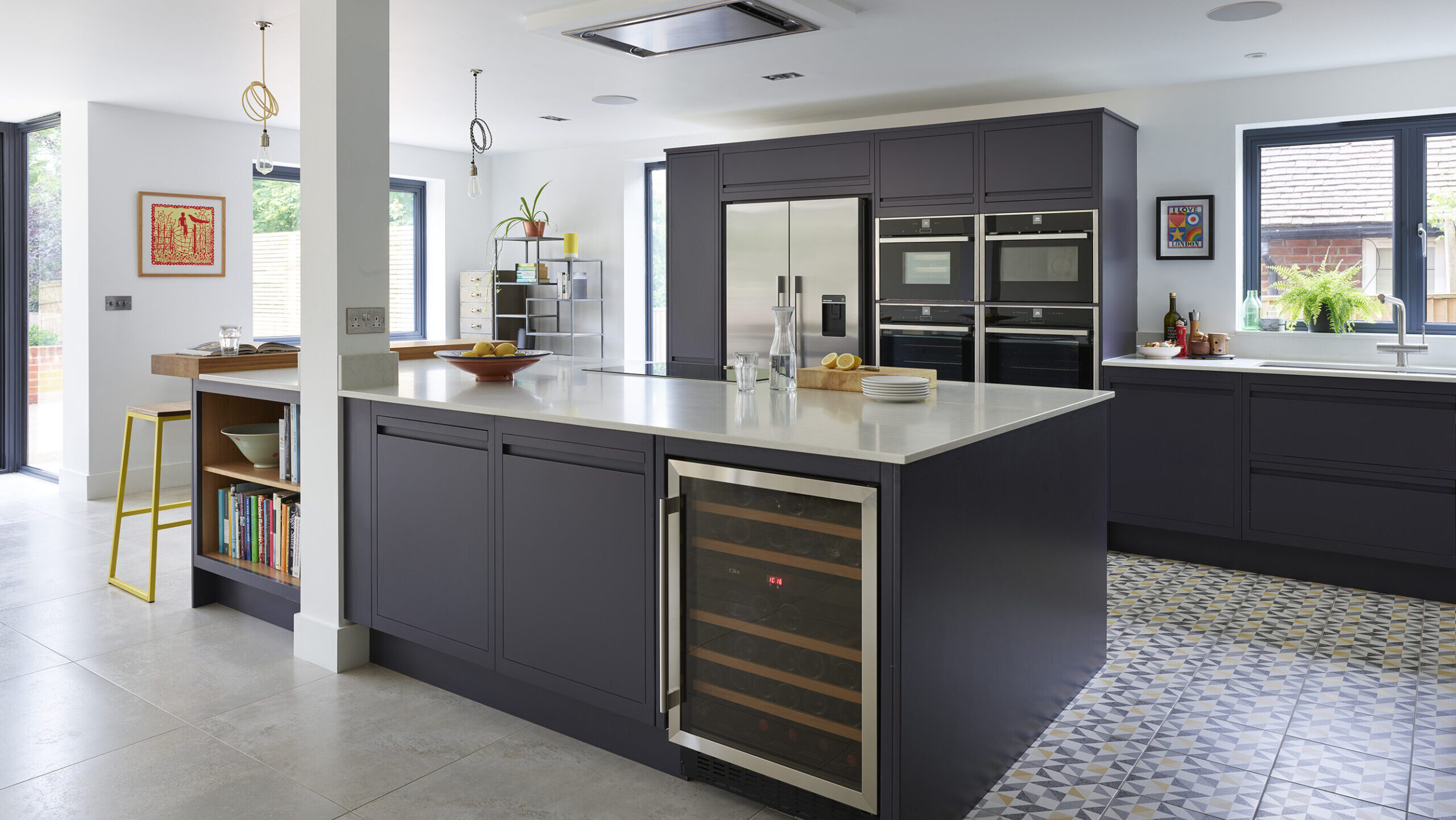 Modern navy blue kitchen with patterned flooring and kitchen island