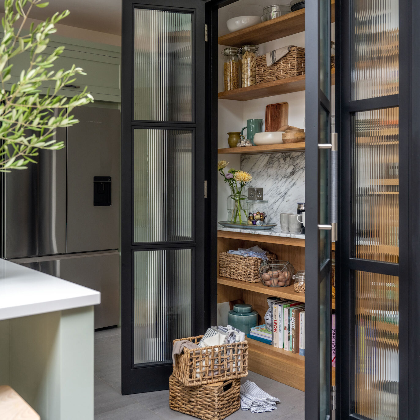Kitchen pantry larder with reeded glass doors and open shelving storage