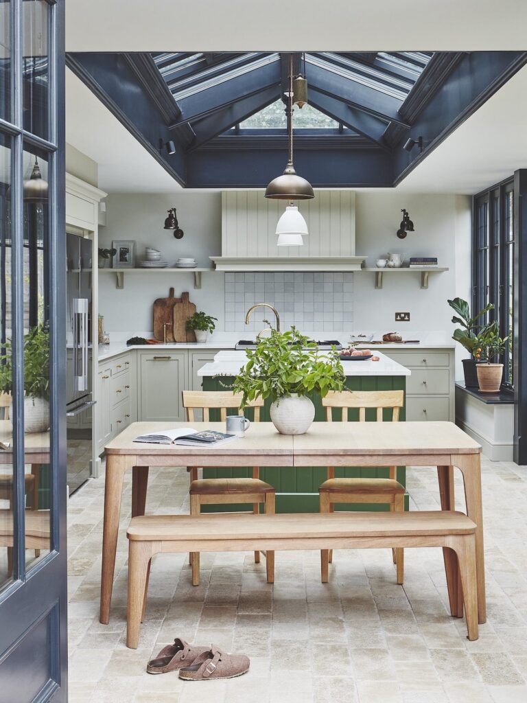Green and white modern kitchen with farmhouse style table and country charm