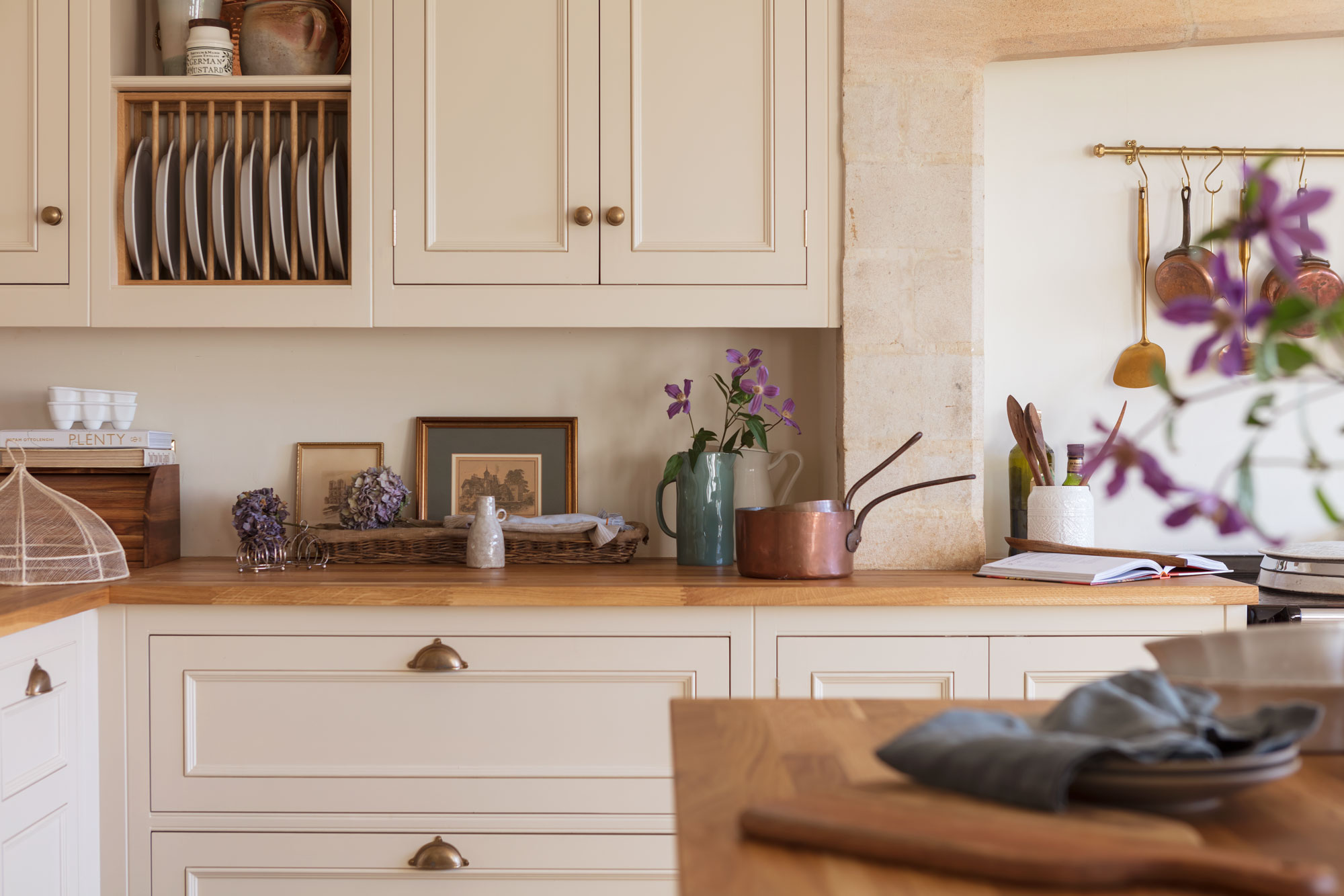 Traditonal country style farmhouse with wooden worktops, brass hardware and plate rack