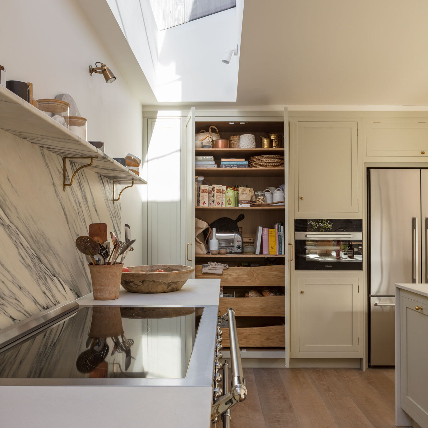 Hidden larder cupboard in a modern kitchen with deep drawers and shelves