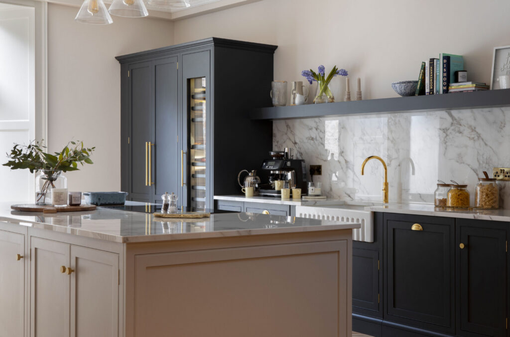 dark blue kitchen with neutral island featuring classic kitchen design and marble splashback