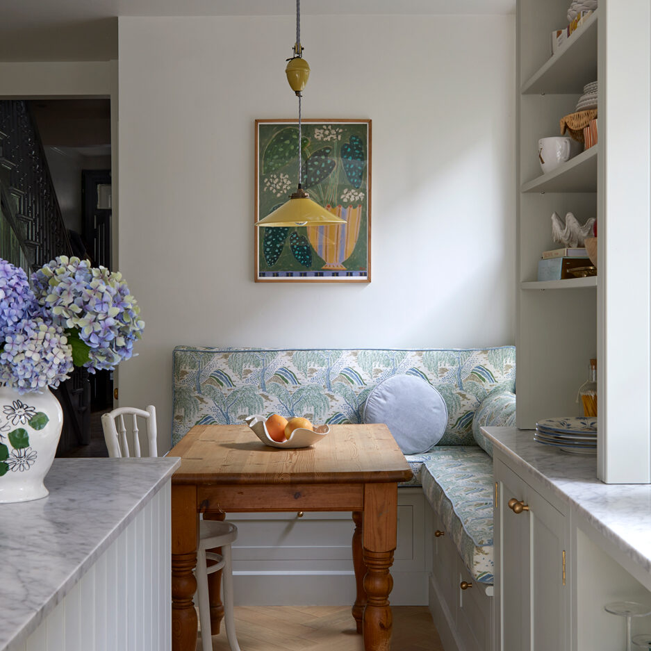 Neutral Shaker style kitchen with built in bench seating with storage and farmhouse table