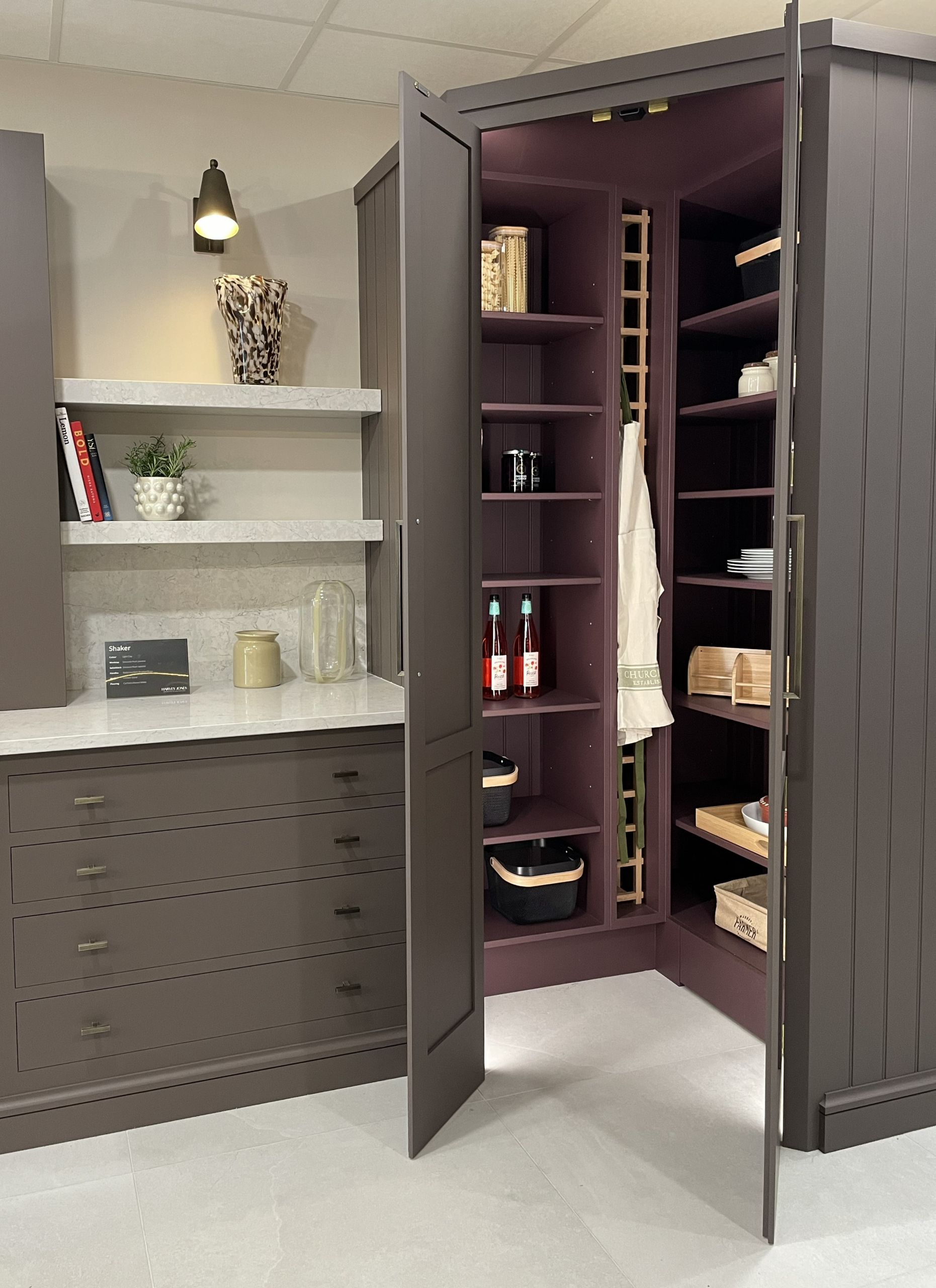 Built in corner pantry with plum cabinetry and bespoke internal shelving with wine, appliances and dried goods