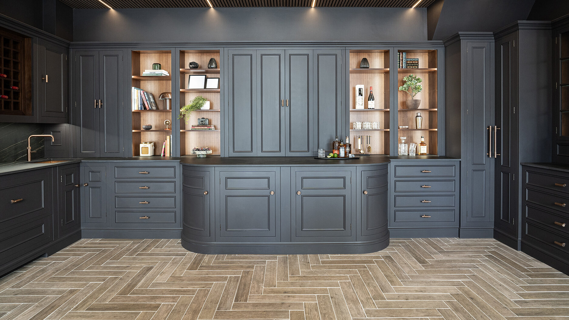 Black traditional kitchen design with bespoke cabinetry and practical corner storage solutions