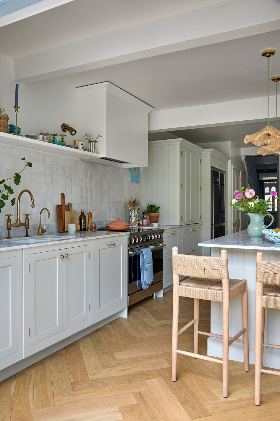 Light sage green shaker kitchen with natural wood accents and zellige splashback tiles