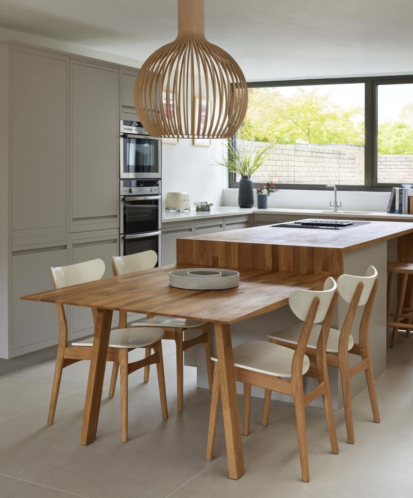 Modern kitchen diner with wooden island and waterfall seating